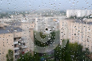 View of the city through the glass with raindrops