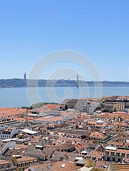 View of the city of Lisbon from the top of St. Georg castle with the 25th of April bridge over the Tagus river, vertical