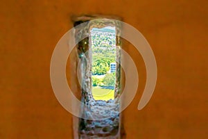 View of the city from the loophole of the observation tower on the upper wall of the Nitrograd castle in Nitra, Slovakia