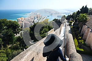 View of the city of Malaga with a woman in hat