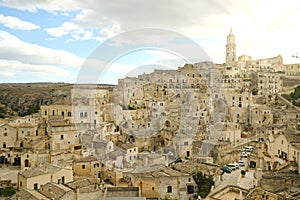 View of the city of Matera in Italy. Church with bell tower and sun