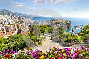 View of the city of Monte Carlo including the Rock, marina, Mediterranean Sea and cityscape along the coast of Monaco.