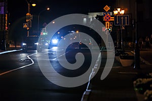 View of city night road with cars standing on crossroad