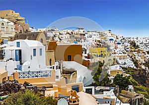 View of the city of Oia with white buildings, hotels, cafes and restaurants. Santorini,