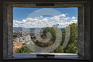 View of the city through one of the windows / embrasures of the Castle of Ljubljana, Slovenia