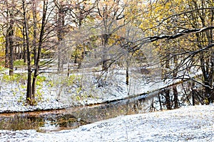 View of city park with river covered with snow