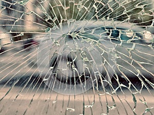 View of city and people through cracked glass