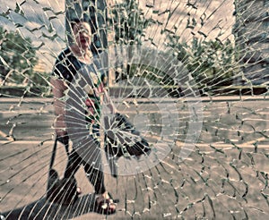 View of city and people through cracked glass