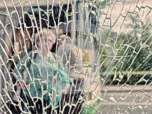 View of city and people through cracked glass