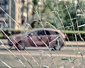 View of city and people through cracked glass