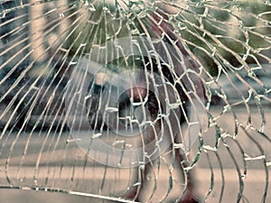 View of city and people through cracked glass photo