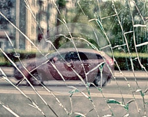 View of city and people through cracked glass photo