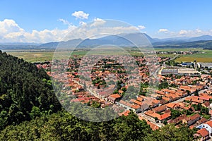 View of the city of Rasnov from a high point in the mountains of Transylvania. Romania