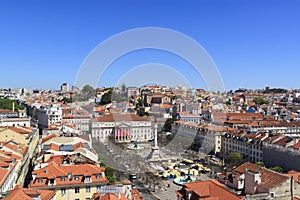 The view of the city from from Santa Justa Lift on a sunny summer day. The roofs of the houses and Rossio Square