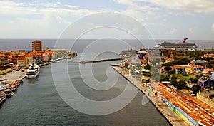 View of the city from the top of Queen Juliana Bridge, with buildings and ships along St Anna Bay near Willemstad, Curacao