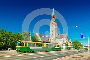 View of a city tram in Helsinki and the old historical building of The National Museum of Finland