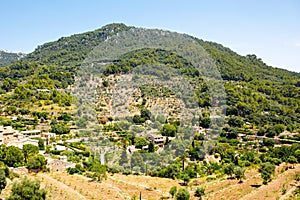 View on city Valldemossa with traditional flower decoration, famous old mediterranean village of Majorca. Balearic