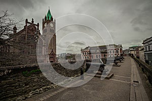 View from the city wall of Derry or Londonderry, place with cannons, overlooking towards the city square with Guildhall in the