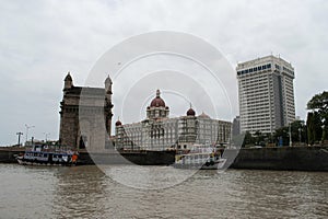 view of cityscape of mumbai with gateway of india, hotel taj mahal and taj tower as distinctive landmark