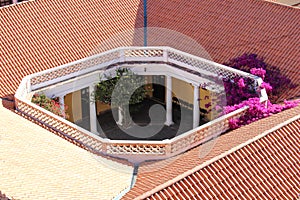 View of classic colonial patio with red tile roofs