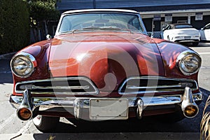 A view of a classic vintage American car in a parking lot