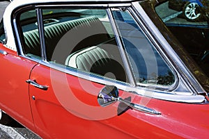 A view of a classic vintage American car in a parking lot