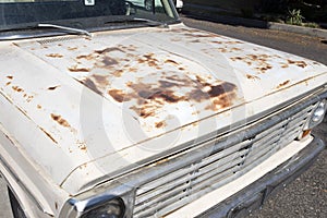 A view of a classic vintage American pick up truck and rusty surface of the body