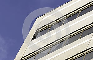 View of clean business building facade in front of deep blue sky