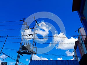 view of clear blue sky in small town of sambas with black power lines photo