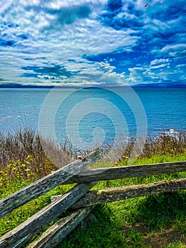 View of the clear sea, wooden fence along the shore