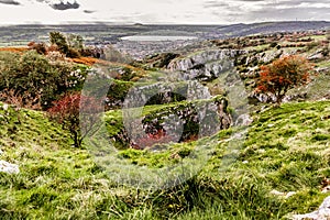 View from cliff edge of winding road Cheddar Town Gorge in Somerset in autumn