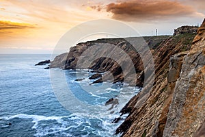 View of a cliff over a coastline with a beautiful misty sea from a view point on a beach in Mossel Bay, Cape Town photo