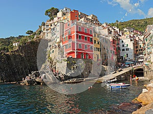 View from the cliff over the sea of Riomaggiore, colors reflected in the water