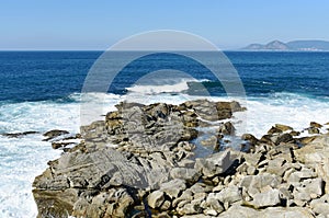 View from a cliff with waves breaking at famous Rias Baixas in Galicia Region. Spain.