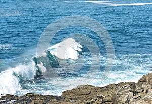 View from a cliff with waves breaking at famous Rias Baixas in Galicia Region. Spain.