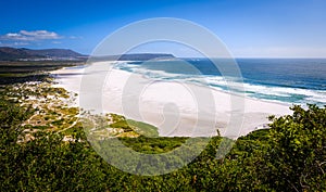 A view looking down at the beautiful white sand beach of noordhoek in the capetown area of south africa.3 photo