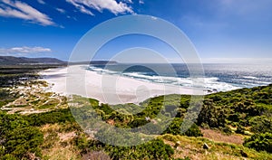 A view looking down at the beautiful white sand beach of noordhoek in the capetown area of south africa.4 photo