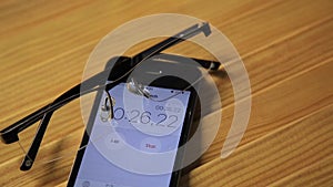 View of close up clock and stopwatch on a smartphone. man starts a stopwatch