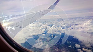 View On Clouds and earth From The Air Company Airplane Window During The