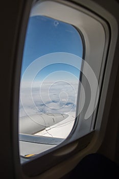 View of clouds, sky and airplane engine from aeroplane window