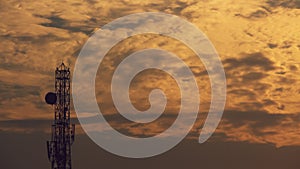 View of the cloudy sky during the sunset with the communication tower