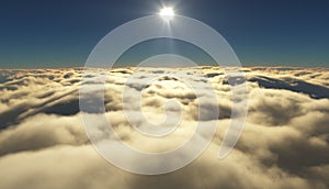 View of a cloudy sunrise while flying above the clouds.