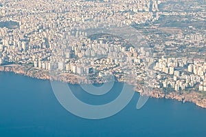 View of the coast of Antalya from the wing of an airplane on a summer day