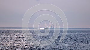 View from the coast on the high-speed Raketa hydrofoil ship going across the Gulf of Finland against the background of thermal p