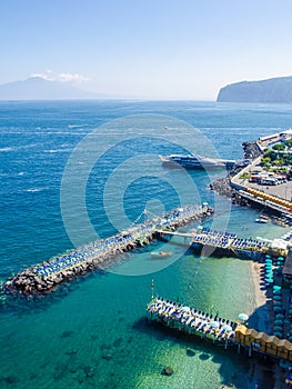 view of coast of italian city sorrento where people may relay on a wooden quay offseting sandy beach....IMAGE