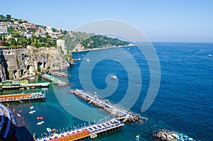 view of coast of italian city sorrento where people may relay on a wooden quay offseting sandy beach....IMAGE