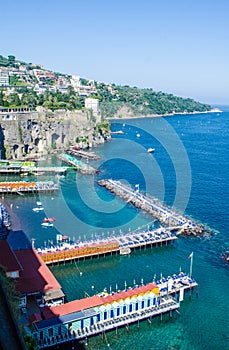 view of coast of italian city sorrento where people may relay on a wooden quay offseting sandy beach....IMAGE