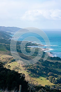 A view of a coast with mountains and haze in the distance