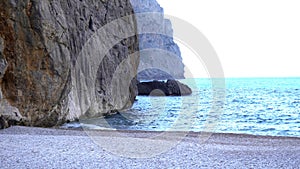 View of coastal cliffs with blue sea. Art. Perfect summer area with blue sea and cliffs. Seascape with cliffs rising