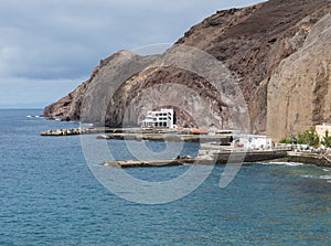 view of coastal cliffs and marina at village Puerto de Sardina del Norte at Grand Canaria, Canary islands, Spain